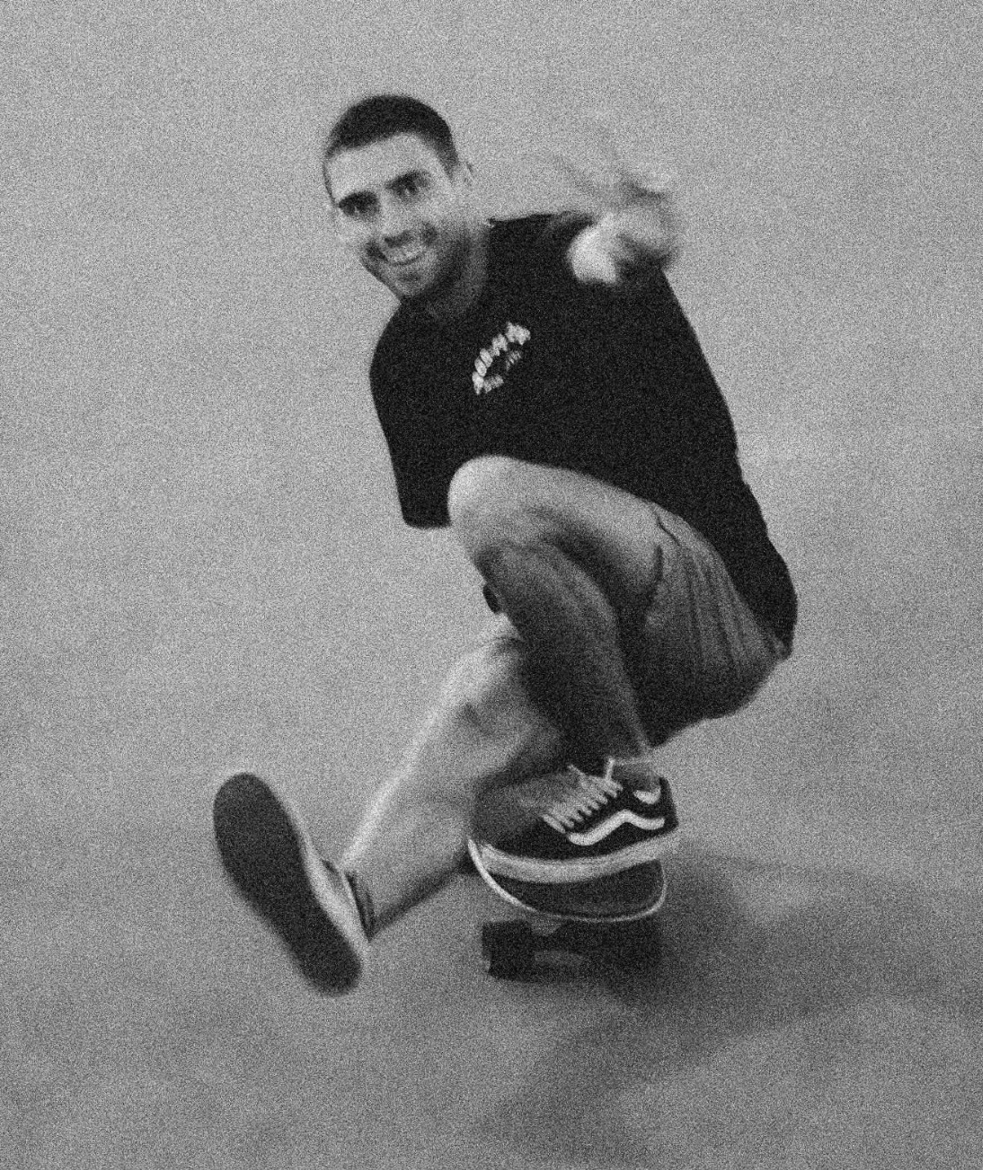 A guy having fun on the surfskate, doing a trick and showing peace.